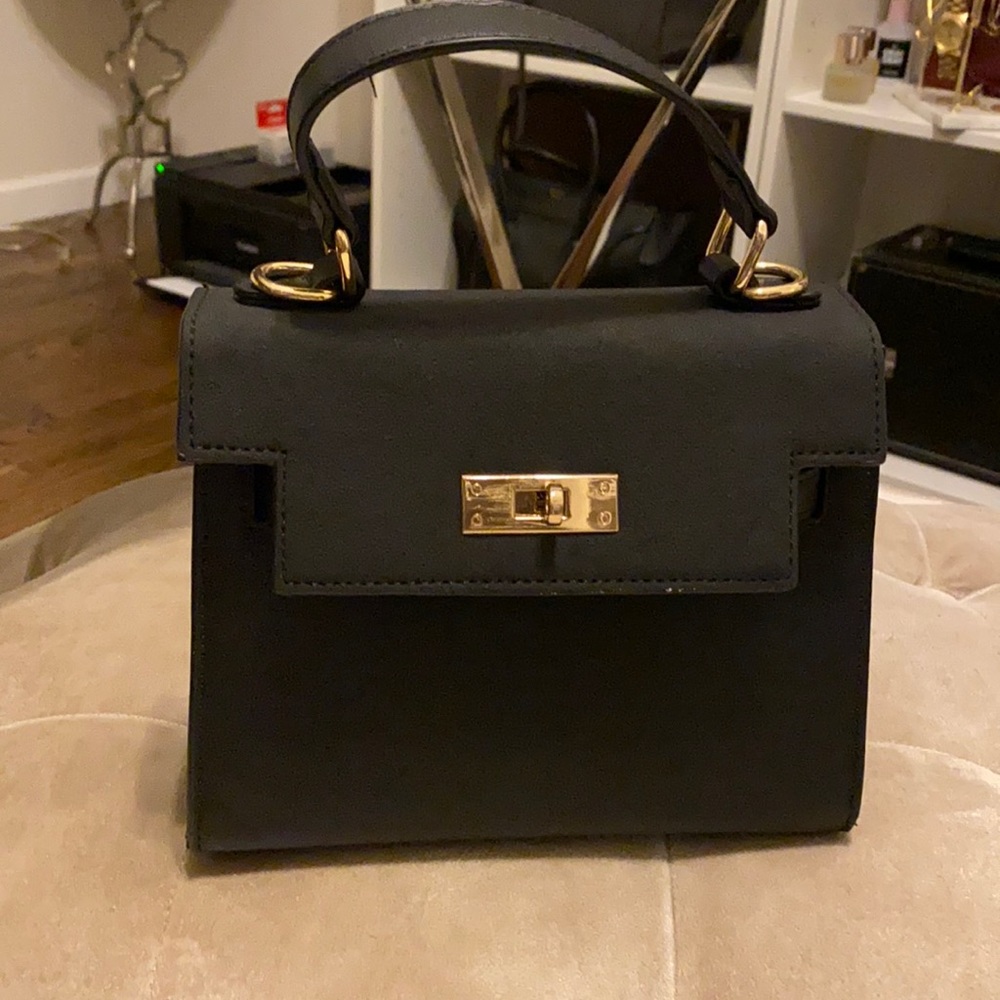 Small black crossbody bag with gold hardware
